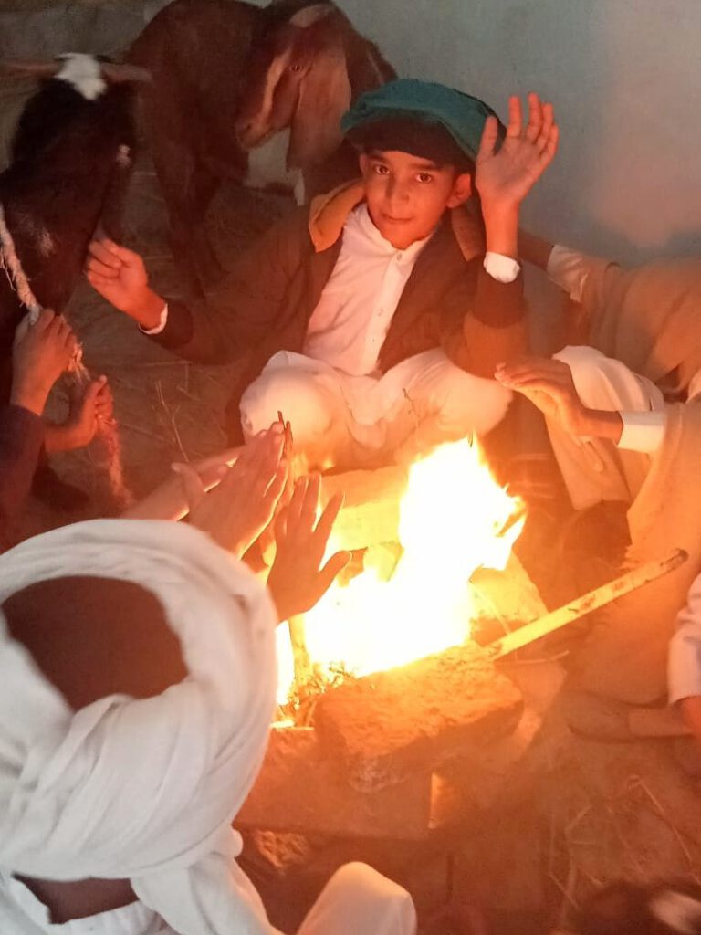 Shepherds sitting around a fire