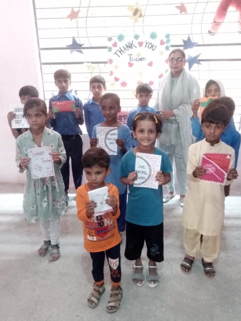 Students with self made cards for teacher's day in one of the new class rooms.